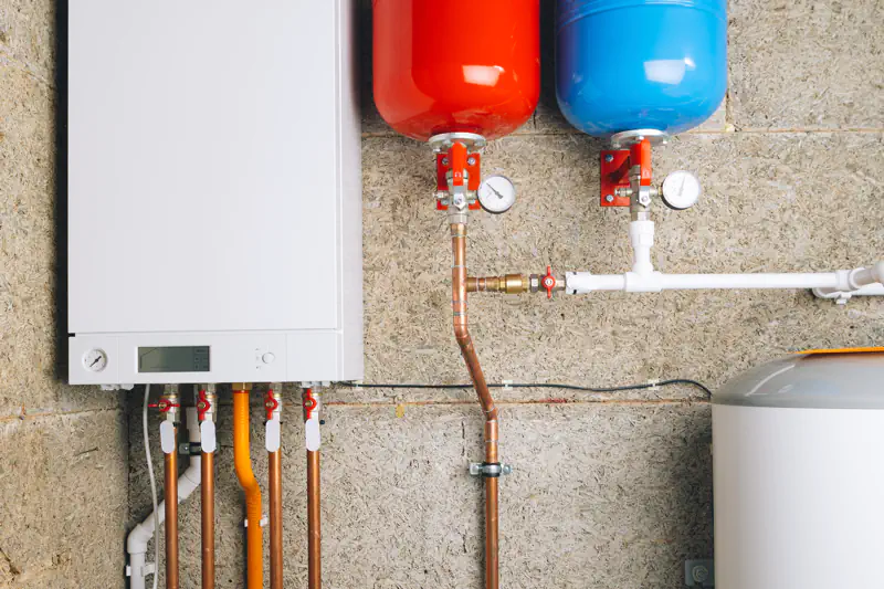 White boiler and red and blue expansion tanks with water heater
